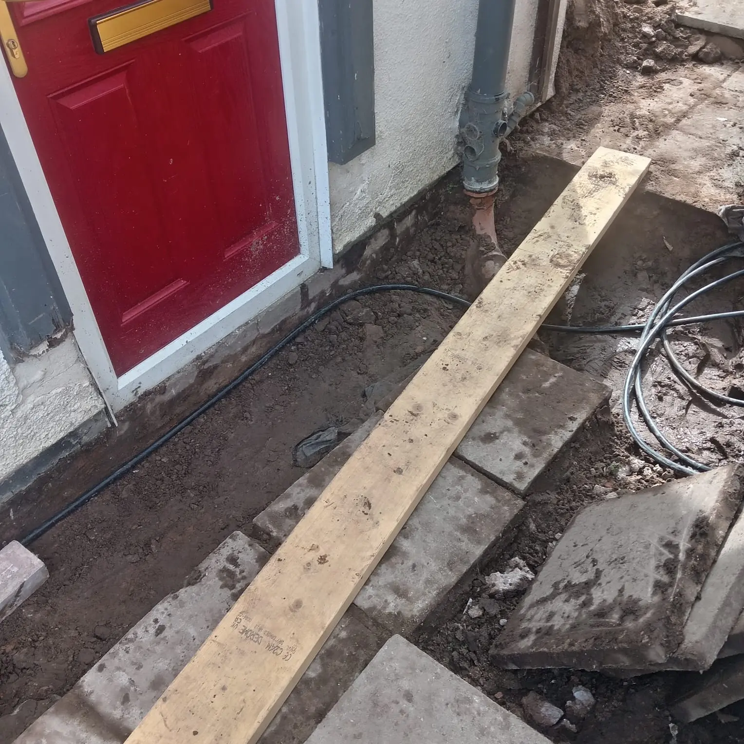 Lifted flagstones and new drainage channel by front door Preston