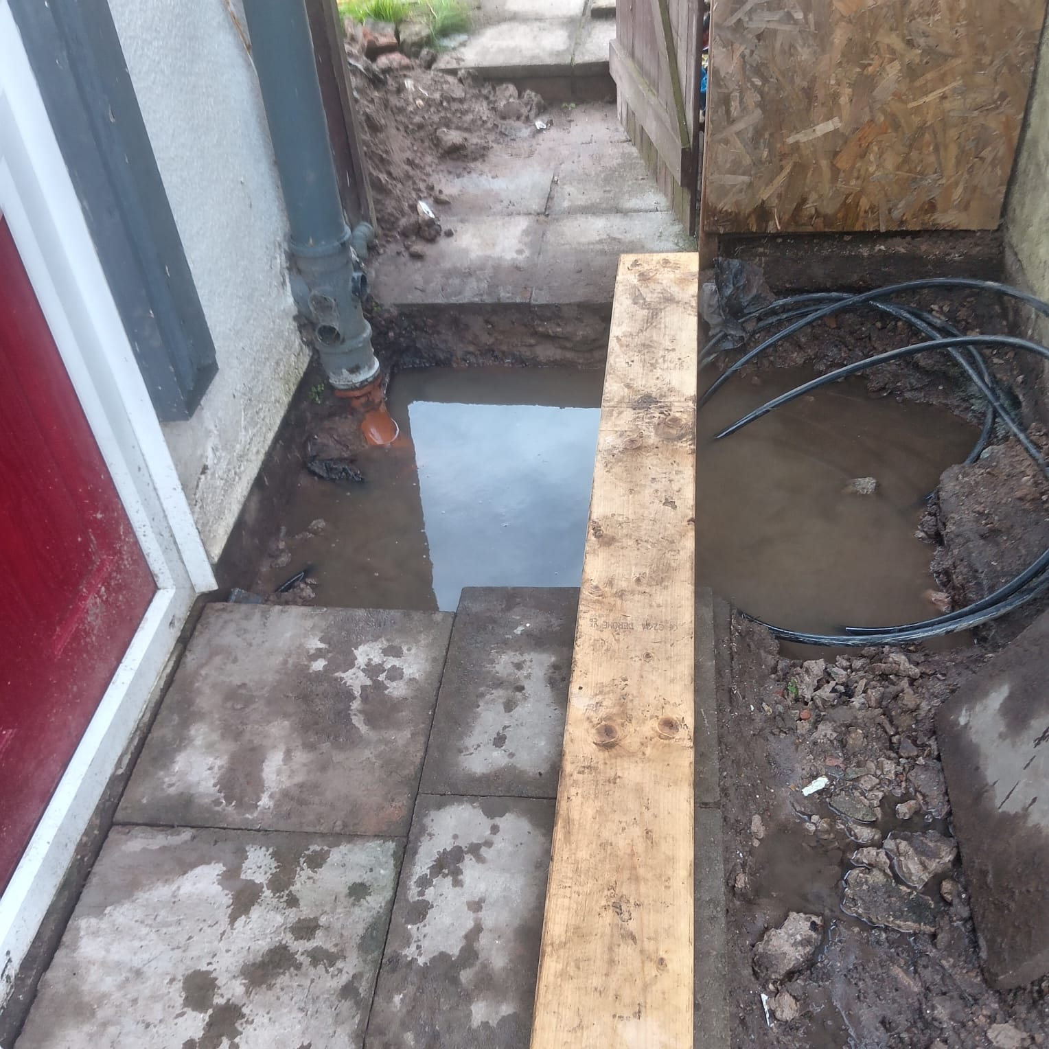 New concrete base poured for drainage repair by front door Preston