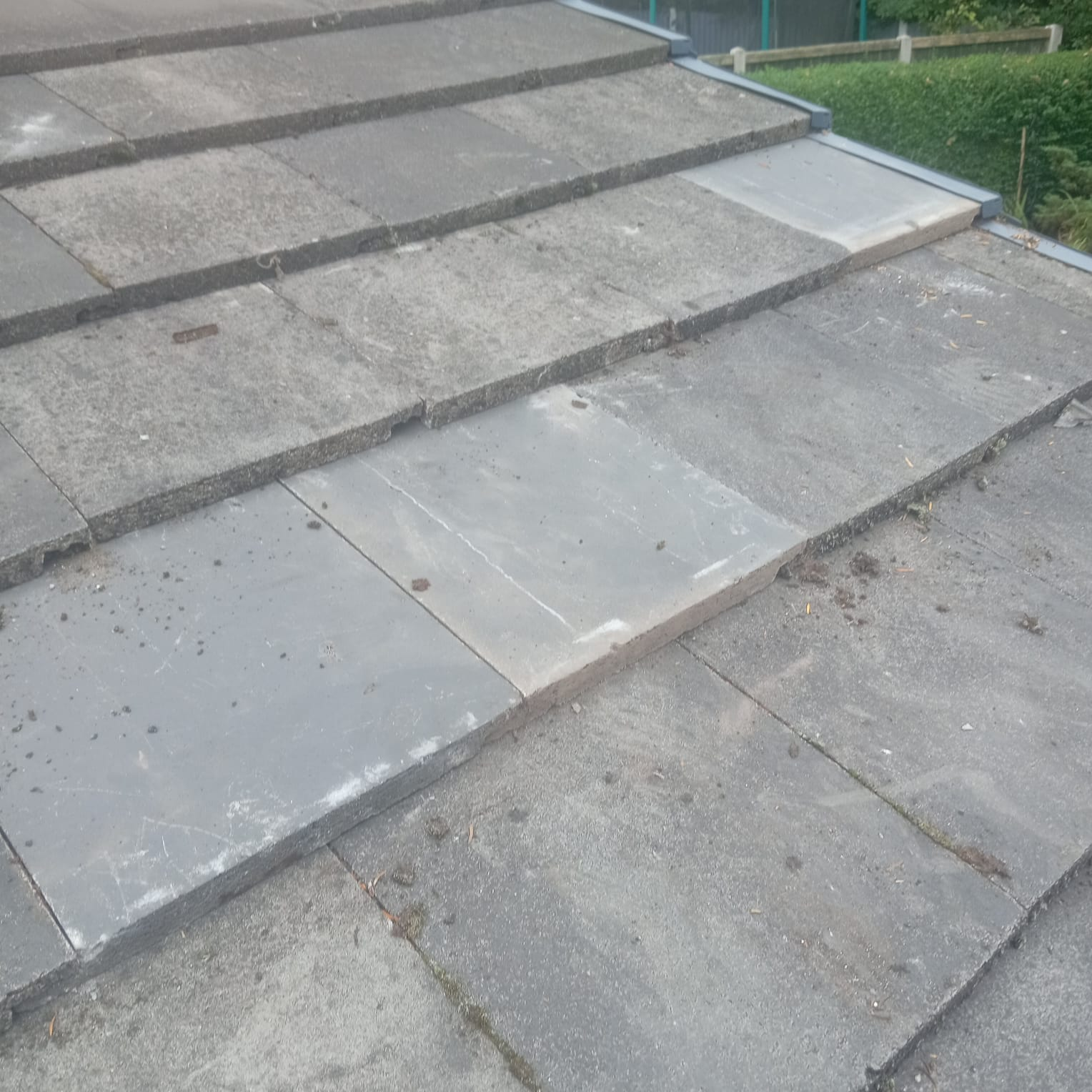 Replacement roof tiles bedded into pitched roof during repair Lancashire