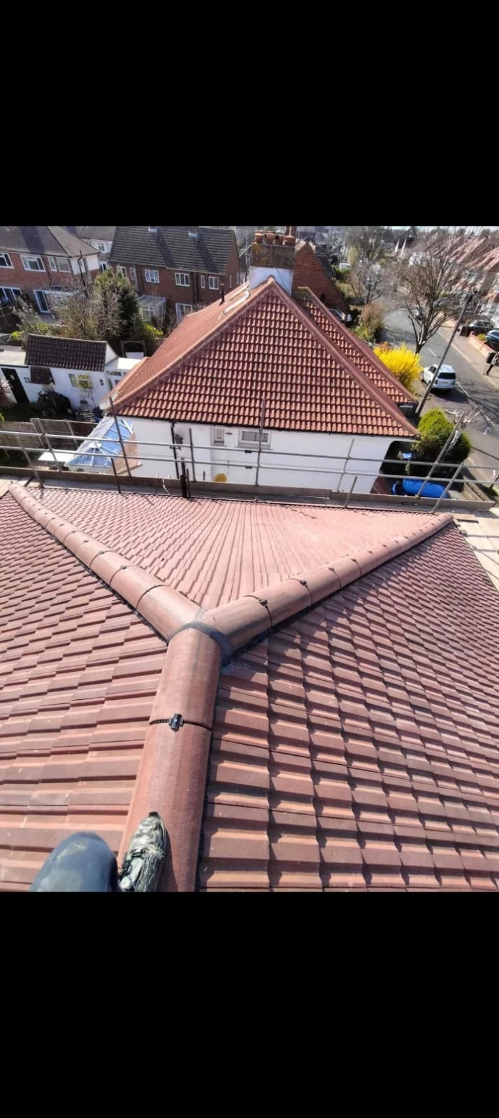 Newly tiled hipped roof with ridge and hip tiles bedded Preston
