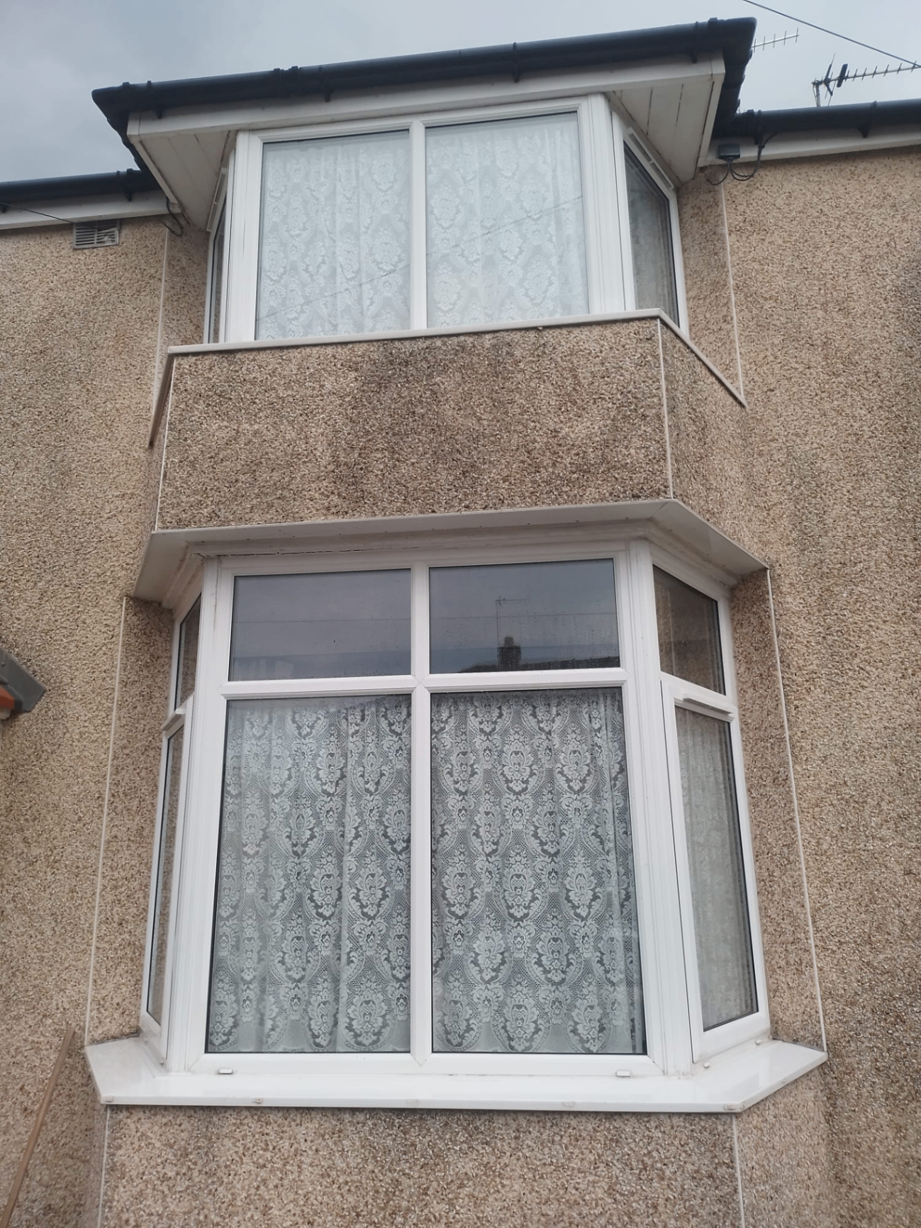 Two storey pebbledash home with bay windows Lancashire