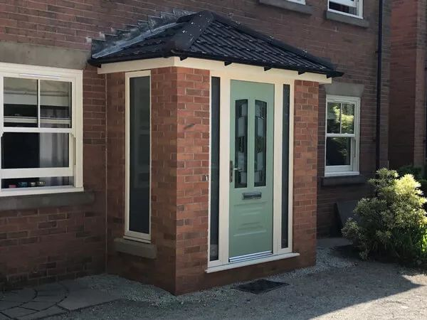 Brick porch with sage green composite door and grey tiled roof Preston