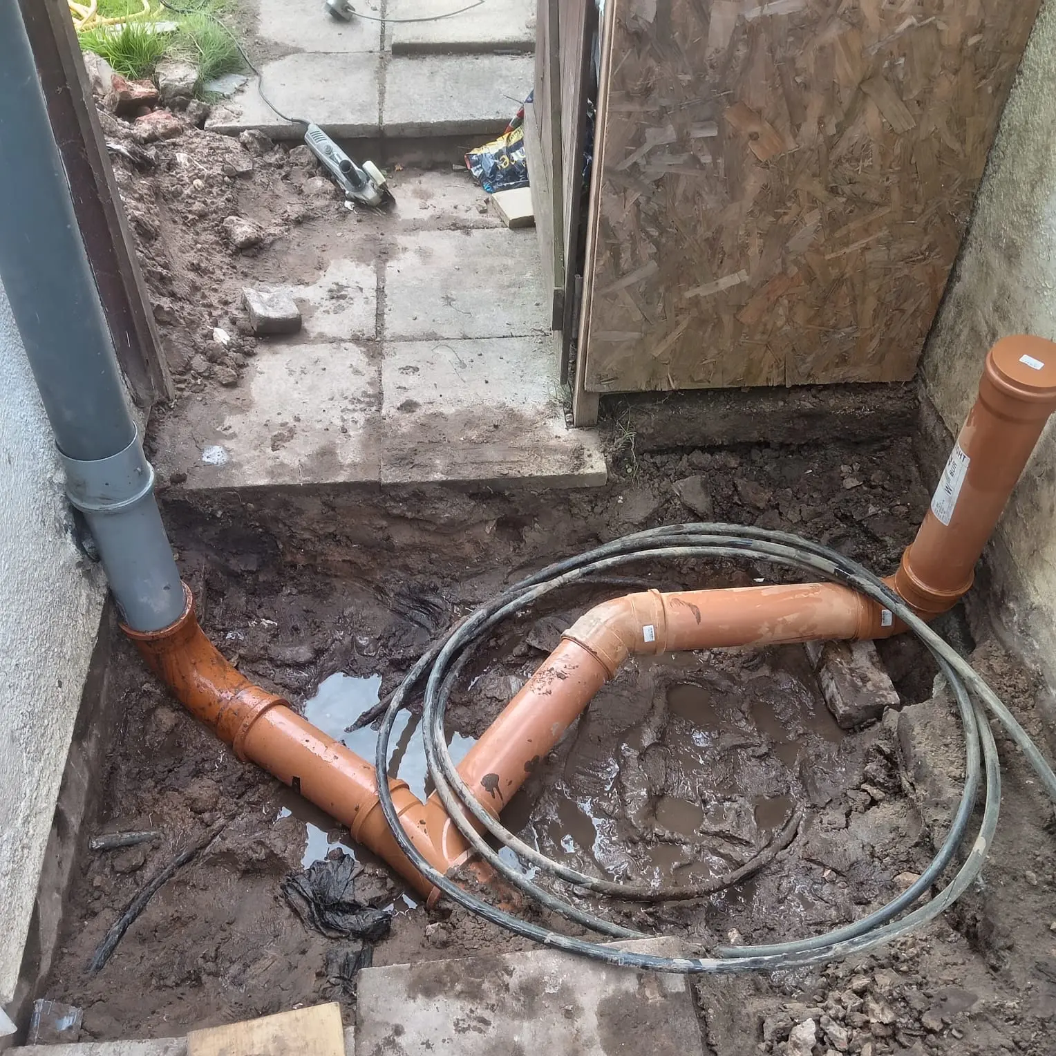New orange PVC underground drainage pipework installation Preston