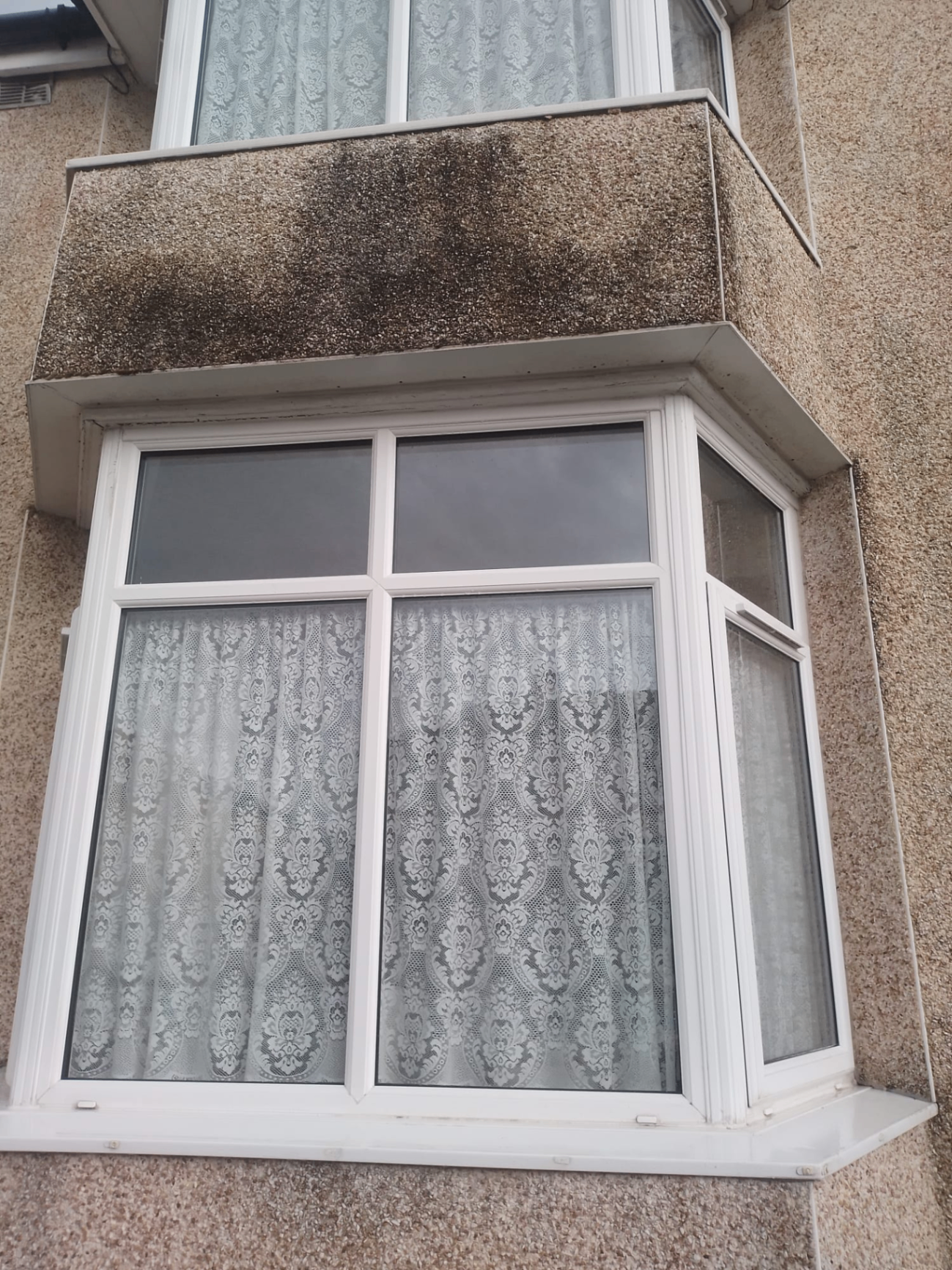 White uPVC bay window with pebbledash render Preston