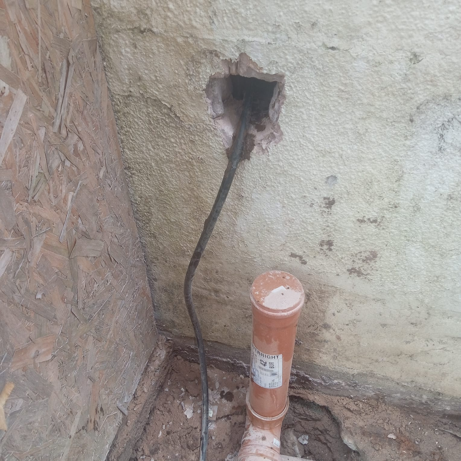 Soil pipe stack connection through rendered wall Lancashire
