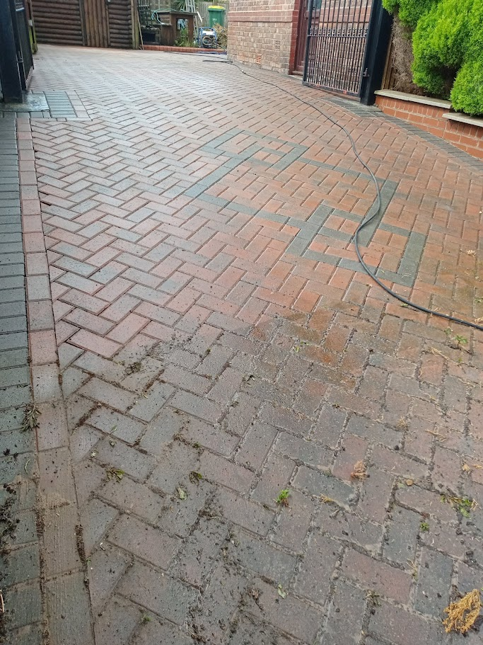 Block paved driveway being cleaned
