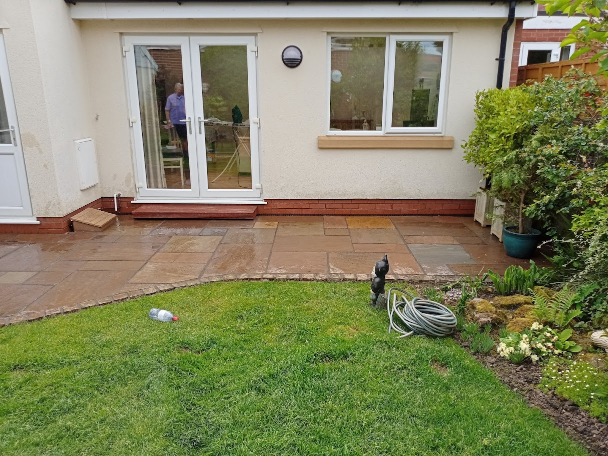 Indian sandstone patio with lawn
